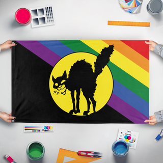 A mockup of the custom flag 'Sabot Pride flag' held up on a table during print checking