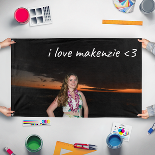 A mockup of the custom flag 'makenzie flag' held up on a table during print checking