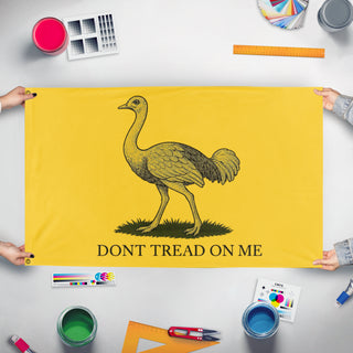 A mockup of the custom flag 'Australian Gadsden Emu flag' held up on a table during print checking