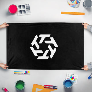 A mockup of the custom flag 'T-hub flag' held up on a table during print checking