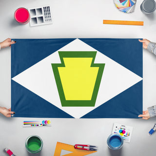 A mockup of the custom flag 'Keystone Diamond flag' held up on a table during print checking