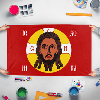 A mockup of the custom flag 'Holy Face of Christ flag' held up on a table during print checking
