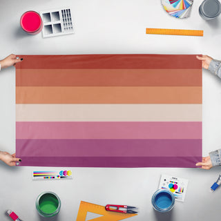 A mockup of the custom flag 'wlw flag' held up on a table during print checking