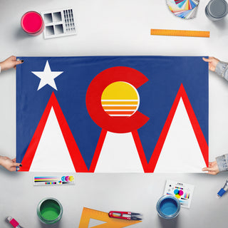 A mockup of the custom flag 'Colorado Pueblo city flag redesign' held up on a table during print checking