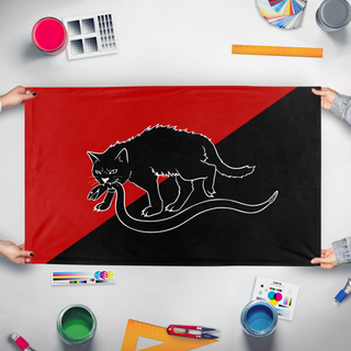 A mockup of the custom flag 'Sabot Tabby Cat flag' held up on a table during print checking