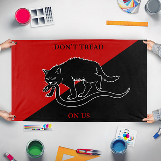 A mockup of the custom flag 'Sabot Cat flag' held up on a table during print checking