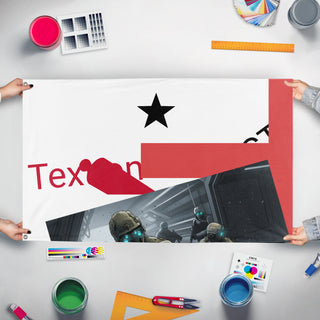 A mockup of the custom flag 'T flag' held up on a table during print checking