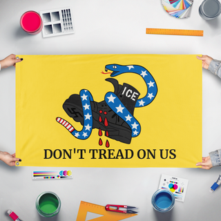 A mockup of the custom flag 'Anti-ICE Gadsden flag' held up on a table during print checking