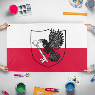 A mockup of the custom flag 'T flag' held up on a table during print checking