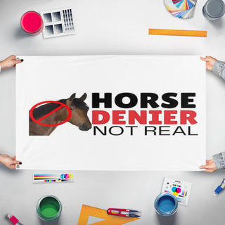 A mockup of the custom flag 'no horse flag' held up on a table during print checking