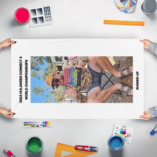 A mockup of the custom flag 'HULA24 flag' held up on a table during print checking