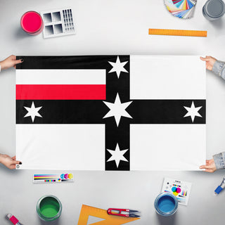 A mockup of the custom flag 'German Colonial flag of Australia' held up on a table during print checking