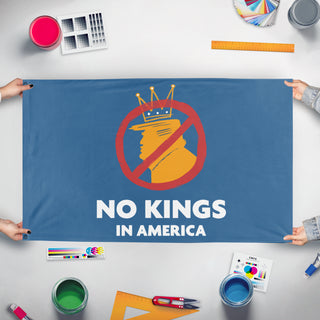 A mockup of the custom flag 'No Kings in America flag' held up on a table during print checking