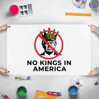 A mockup of the custom flag 'No Kings in America flag' held up on a table during print checking