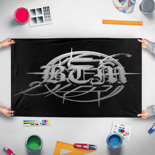 A mockup of the custom flag 'BTM flag' held up on a table during print checking