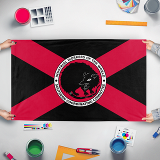 A mockup of the custom flag 'Syndicalist Florida Possum flag' held up on a table during print checking
