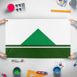 A mockup of the custom flag 'Randolph, NH flag' held up on a table during print checking