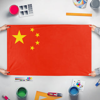 A mockup of the custom flag 'China, People's Republic Of flag' held up on a table during print checking