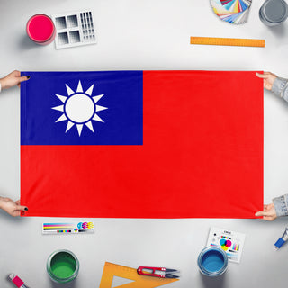 A mockup of the custom flag 'Kuomintang flag' held up on a table during print checking