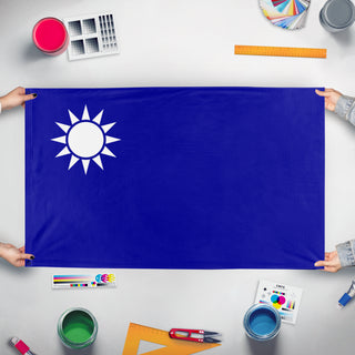 A mockup of the custom flag 'Kuomintang Canton Battle flag' held up on a table during print checking
