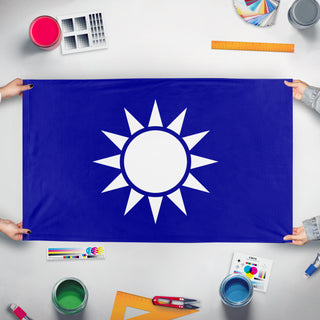 A mockup of the custom flag 'Kuomintang Party flag' held up on a table during print checking