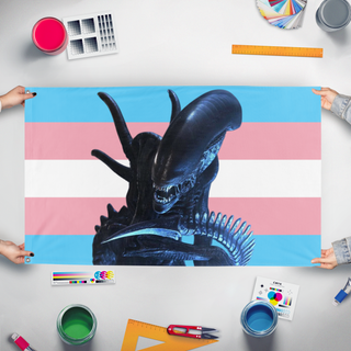 A mockup of the custom flag 'Transxenomorph flag' held up on a table during print checking