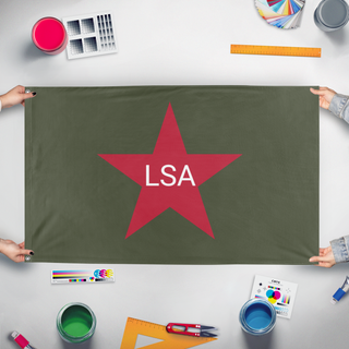 A mockup of the custom flag 'LSA flag' held up on a table during print checking