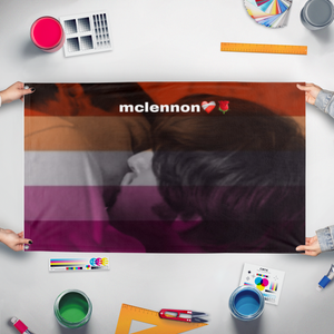 A mockup of the custom flag 'mclennon flag' held up on a table during print checking