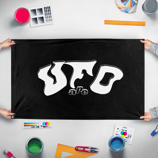 A mockup of the custom flag 'UFO ape  flag' held up on a table during print checking