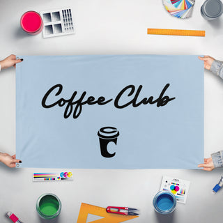 A mockup of the custom flag 'Coffee Club flag' held up on a table during print checking