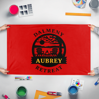 A mockup of the custom flag 'Dalmeny Retreat flag' held up on a table during print checking