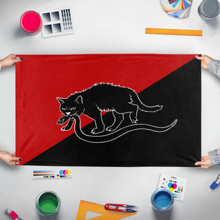 A mockup of the custom flag 'Anarcho-Syndicalist flag' held up on a table during print checking