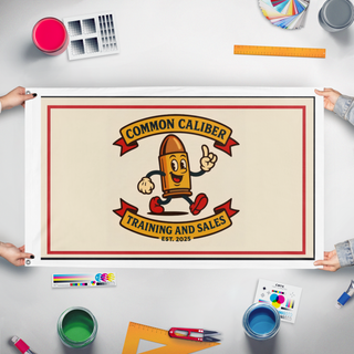 A mockup of the custom flag 'Common Caliber  flag' held up on a table during print checking