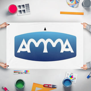 A mockup of the custom flag 'AMMA flag' held up on a table during print checking