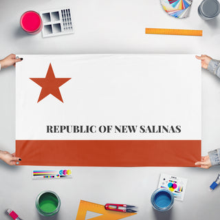 A mockup of the custom flag 'Salinas flag' held up on a table during print checking