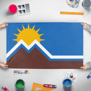 A mockup of the custom flag 'Moreno Valley redesign flag' held up on a table during print checking