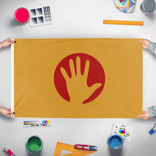 A mockup of the custom flag 'Humanity' held up on a table during print checking