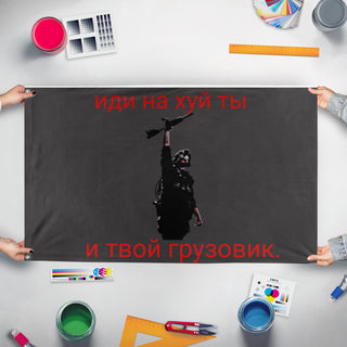 A mockup of the custom flag 'The QB flag' held up on a table during print checking