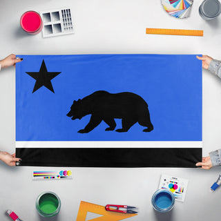 A mockup of the custom flag 'Republic of Monterey Bay flag' held up on a table during print checking