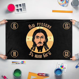A mockup of the custom flag 'Holy Face of Christ flag' held up on a table during print checking