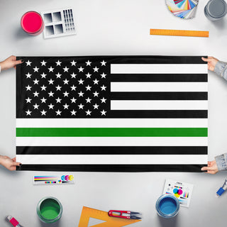 A mockup of the custom flag 'Thin Green Line flag' held up on a table during print checking