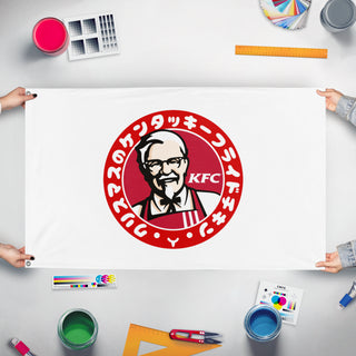 A mockup of the custom flag 'kfchristmasa flag' held up on a table during print checking