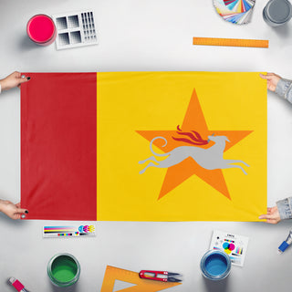 A mockup of the custom flag 'Distributism flag' held up on a table during print checking