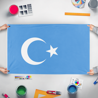 A mockup of the custom flag 'East Turkestan flag' held up on a table during print checking