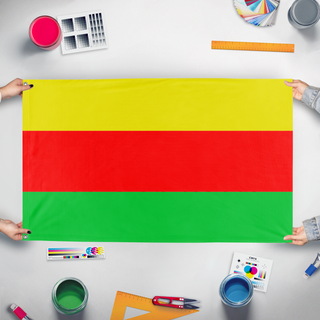 A mockup of the custom flag 'Rojava flag' held up on a table during print checking