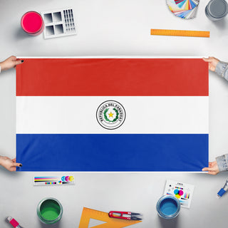 A mockup of the custom flag 'paraguaydesk flag' held up on a table during print checking