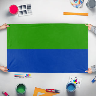 A mockup of the custom flag 'hamstan_gp-new flag' held up on a table during print checking