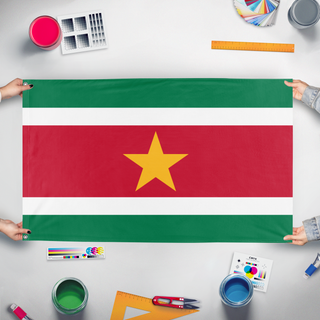 A mockup of the custom flag 'Suriname flag' held up on a table during print checking