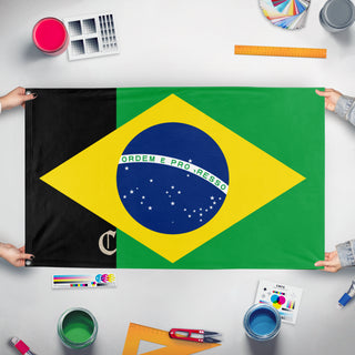 A mockup of the custom flag 'T flag' held up on a table during print checking