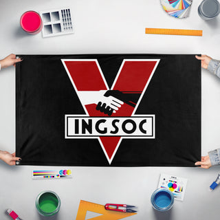 A mockup of the custom flag 'INGSOC flag' held up on a table during print checking